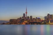 TORONTO, CANADA - June 03, 2017: Downtown Toronto skyline, harbourfront , the CN Tower and the Financial District skyscrapers at sunset from Polson Pier