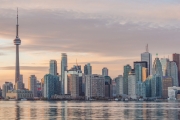 TORONTO, CANADA - NOVEMBER 02, 2015: Downtown Toronto skyline with the CN Tower apex and the Financial District skyscrapers - illuminated at sunset.