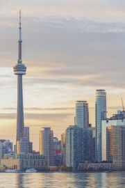TORONTO, CANADA - NOVEMBER 02, 2015: Downtown Toronto skyline with the CN Tower apex and the Financial District skyscrapers - illuminated at sunset.